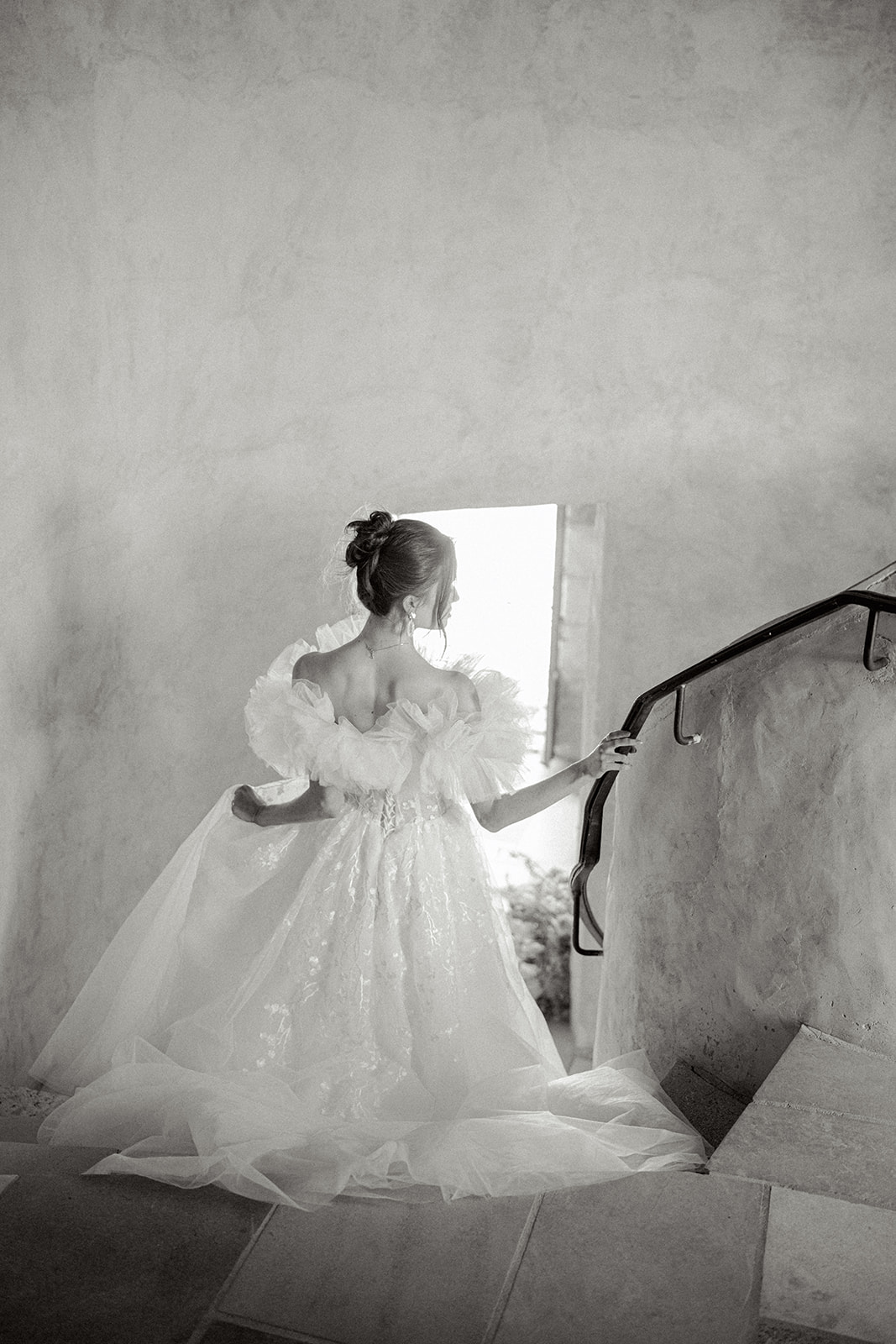 bride walking down stairs looking over her right shoulder