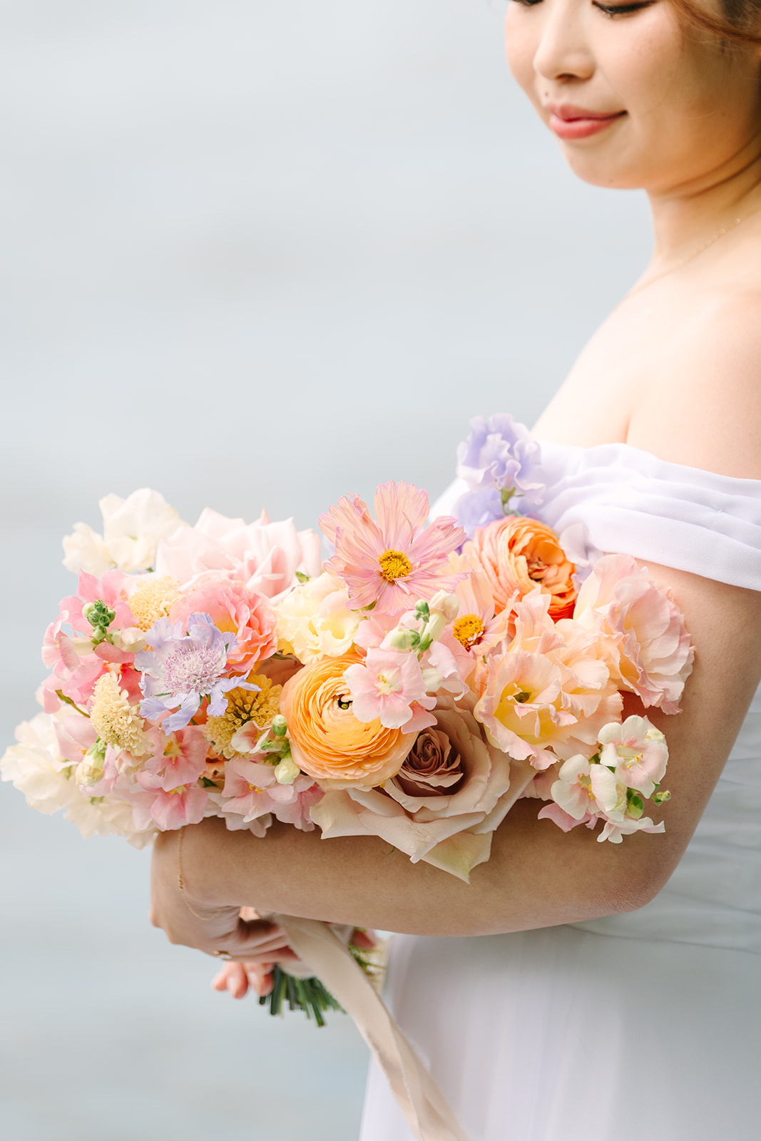 Bride holding her bridal flowers and looking them