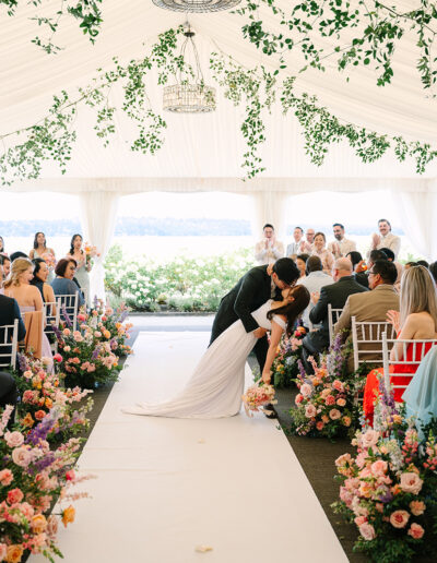 Couple kissing during their wedding ceremony precessional