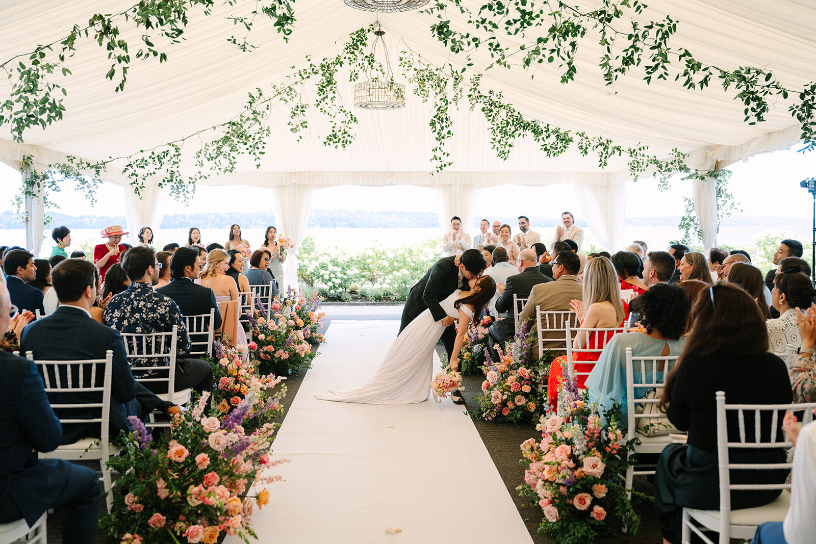 Couple kissing during their wedding ceremony precessional