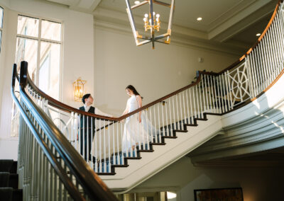 Groom leading Bride walking down stairs